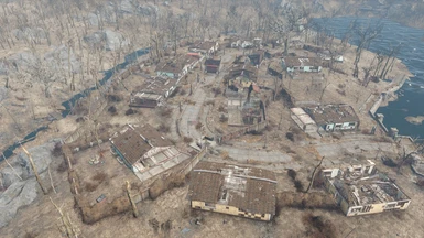 Aerial view from the West - settlement walls visible, showing areas left for player customization