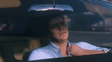 Donovan complains how hot it is in this scene, so it would make sense he would be sweaty and had his jacket off.