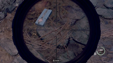 In-game preview #15, looking through a scope at a 5.56 Rifle on the ground.